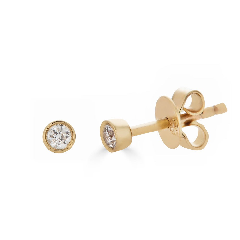 DIAMOND BEZEL STUD-Studs-This is the classic stud, a single diamond set in a 14k solid gold bezel setting for a clean and modern look. - available in 14k yellow and white gold - 2.3 mm circumference - diamond in a single stud: approximately 0.05 total carat weight; G-H color, SI 1-2 clarity - 14k gold butterfly backing - shown on model in yellow gold - custom size diamonds available: ice@anneauxjewelry.com-Anneaux Jewelry