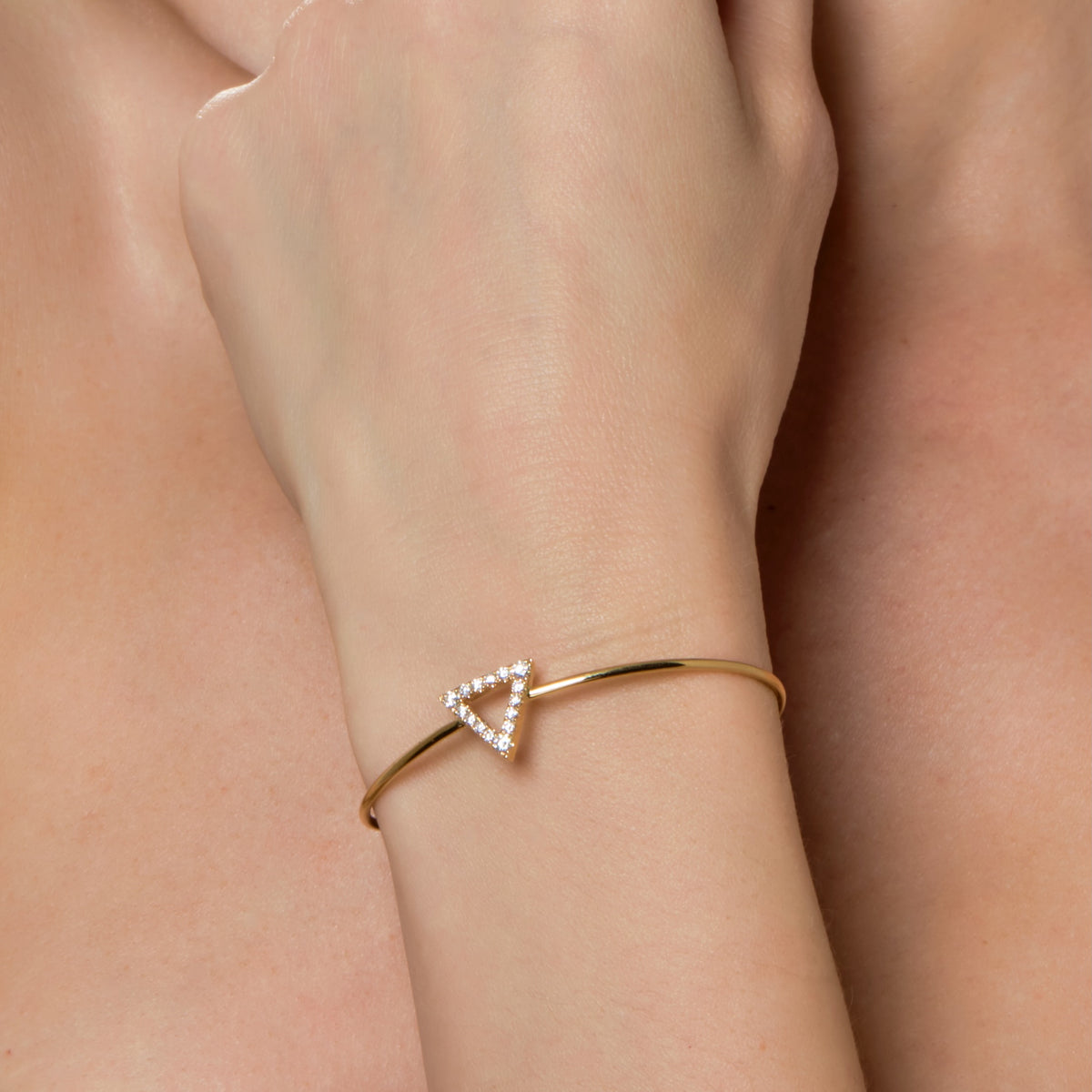 DIAMOND TRIANGLE BANGLE-Bangle-A diamond triangle sits on top of a gold wire bangle, a modern classic for your wrist. - available in 18k yellow or white gold - 55 x 45 mm - diamonds: 0.45 approximate total carat weight; G-H color; SI clarity-Anneaux Jewelry